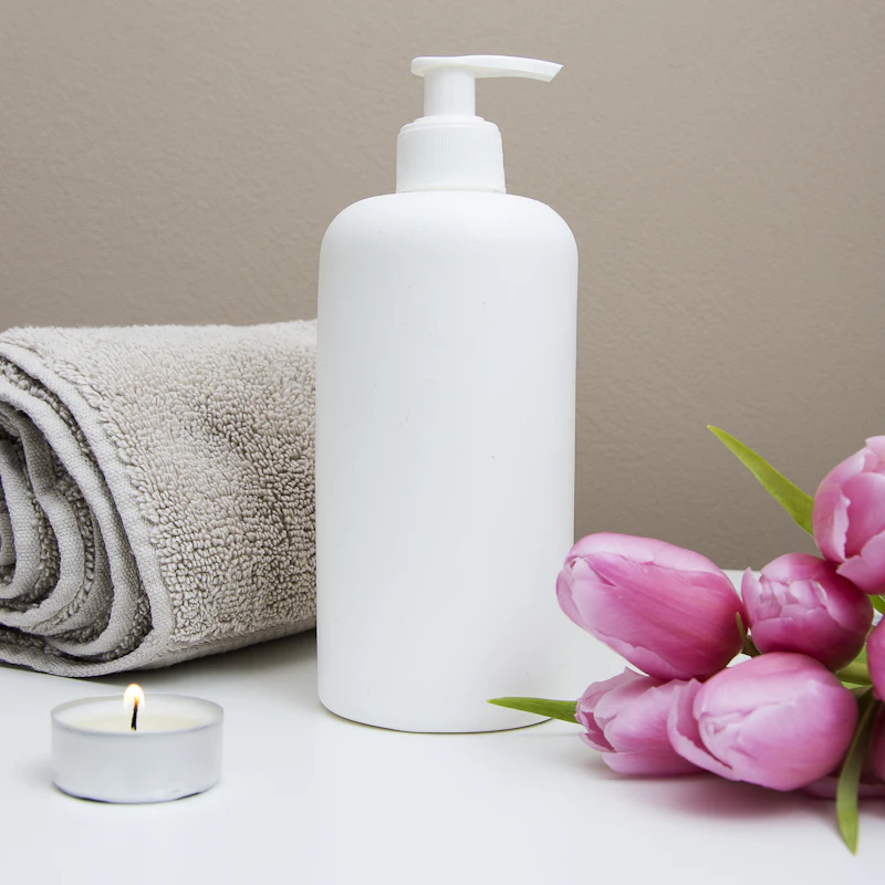 Spa towel, candle and fresh tulips in the treatment room