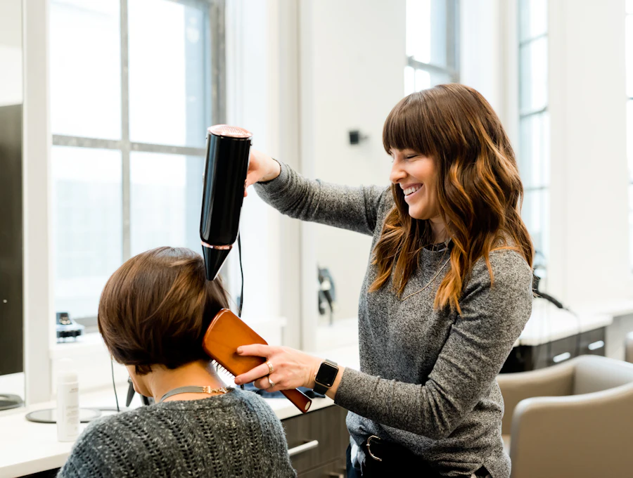 Stylist blow-drying a client's hair
