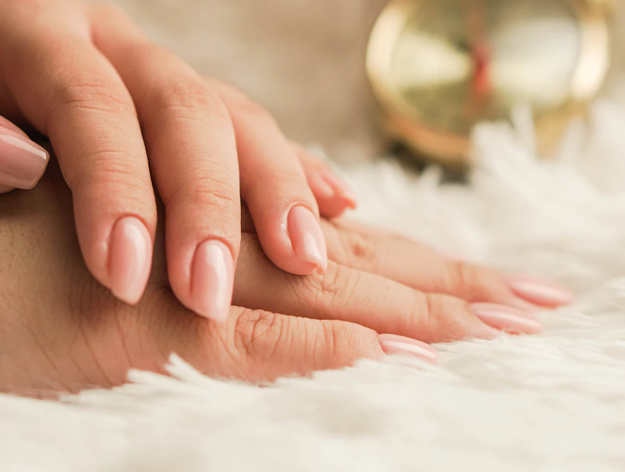 Natural nude manicure on resting hands